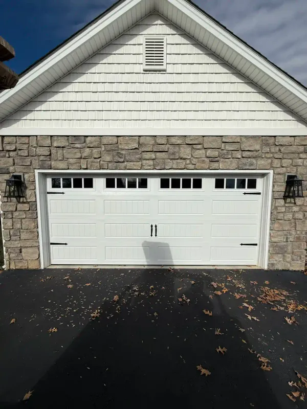 White garage door with horizontal window panes on contemporary stone home in Salem