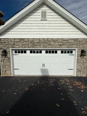White garage door with horizontal window panes on contemporary stone home in Salem